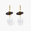Gold hoop earrings with dark wood beads and baroque freshwater pearls, shown from multiple angles on cream background.