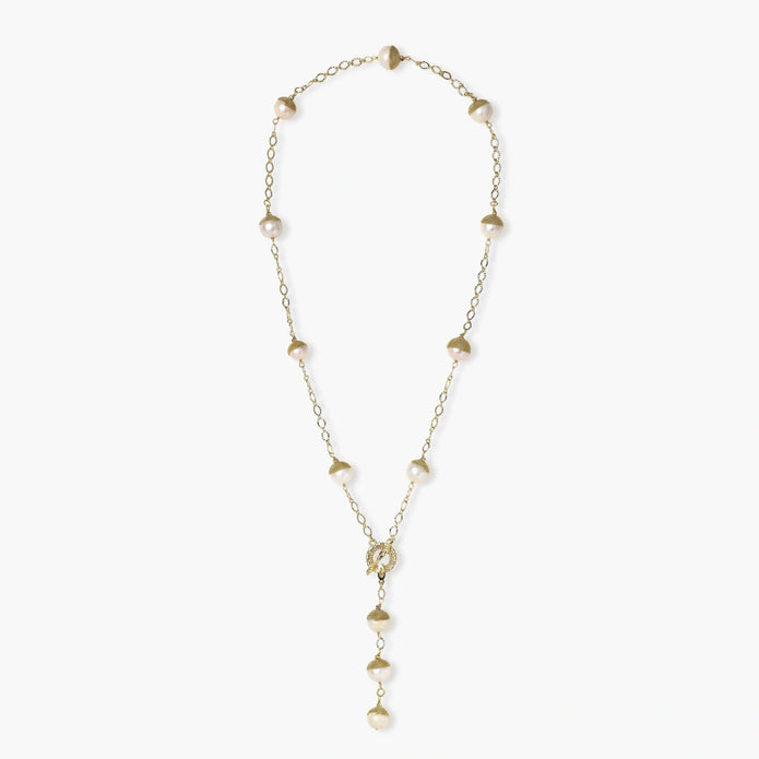 Gold-plated lariat necklace with baroque pearls and textured caps on cream background, showing adjustable Y-shaped design.
