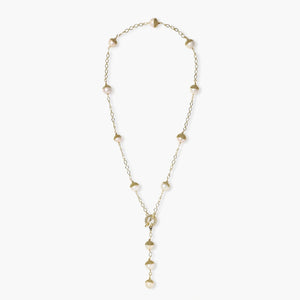 Gold-plated lariat necklace with baroque pearls and textured caps on cream background, showing adjustable Y-shaped design.
