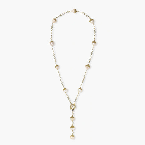 Gold-plated lariat necklace with baroque pearls and textured caps on cream background, showing adjustable Y-shaped design.