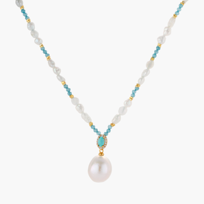 Beaded necklace with baroque pearls, turquoise stones, and gold accents featuring a large pearl pendant on white background.