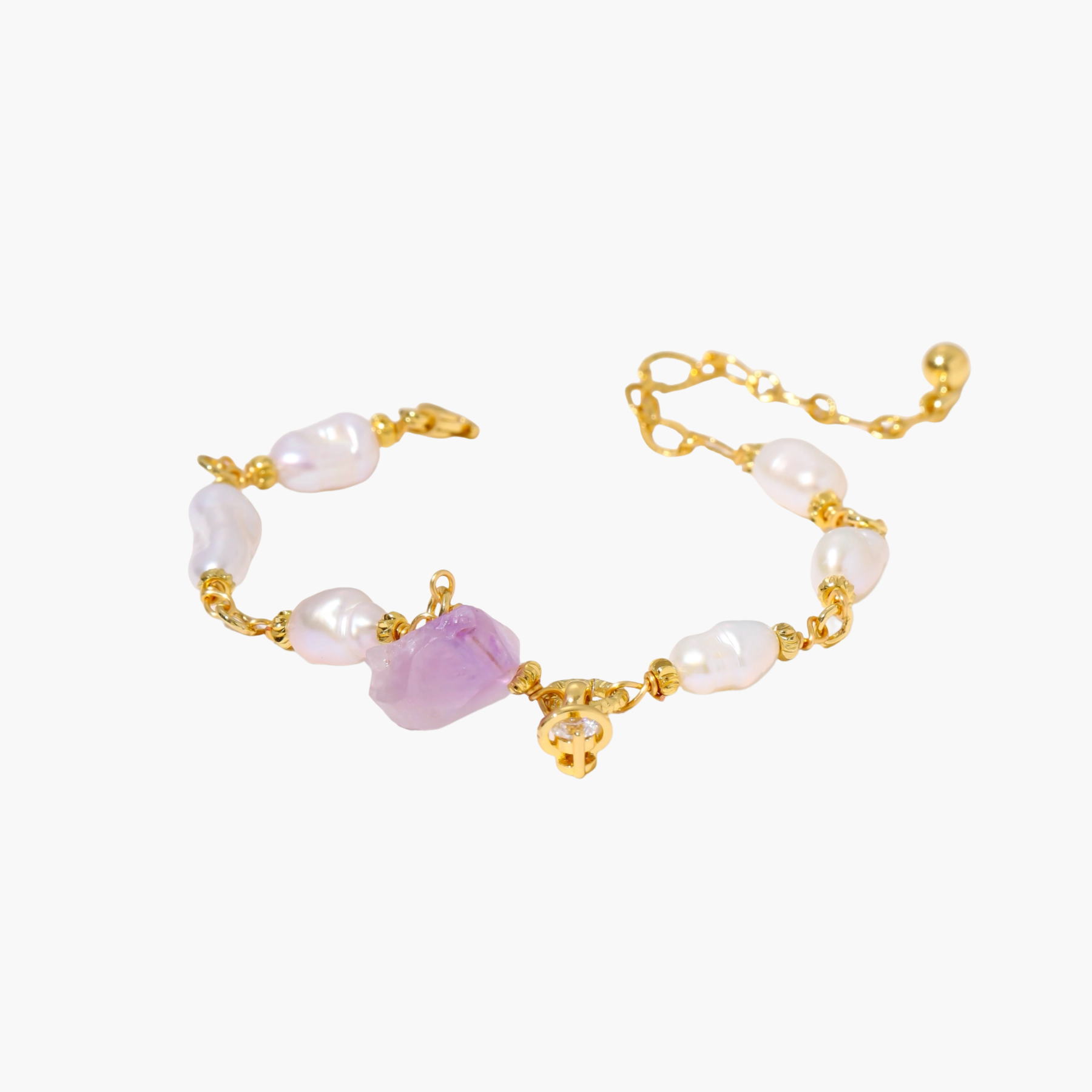 Gold-plated bracelet with lustrous baroque pearls and raw lavender amethyst centerpiece on white background.