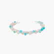Delicate wire-wrapped bracelet featuring turquoise, rose quartz, freshwater pearls, and zircon on a white background.