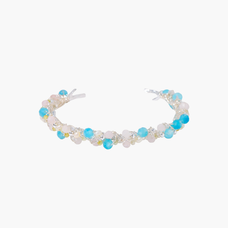 Delicate wire-wrapped bracelet featuring turquoise, rose quartz, freshwater pearls, and zircon on a white background.