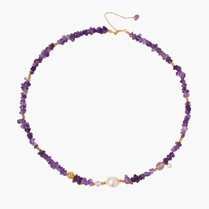 Beaded necklace with purple amethyst chips, freshwater pearls, and gold accents on white background.