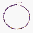 Beaded necklace with purple amethyst chips, freshwater pearls, and gold accents on white background.