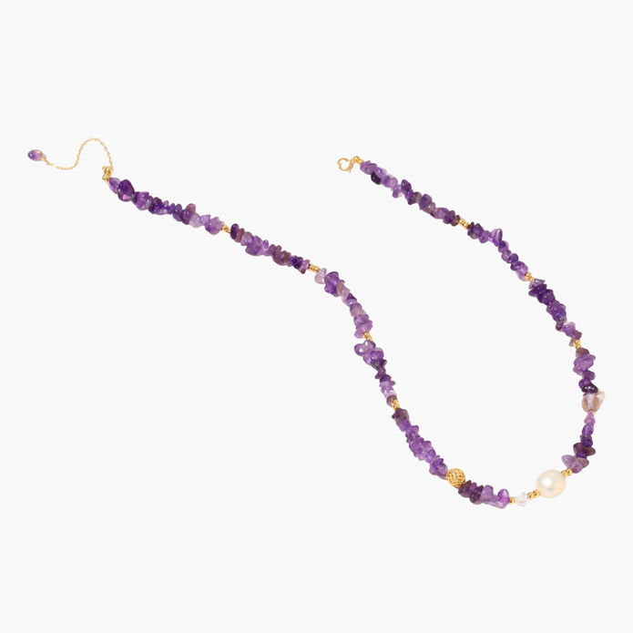 Beaded necklace with purple amethyst chips, freshwater pearls, and gold accents on white background.