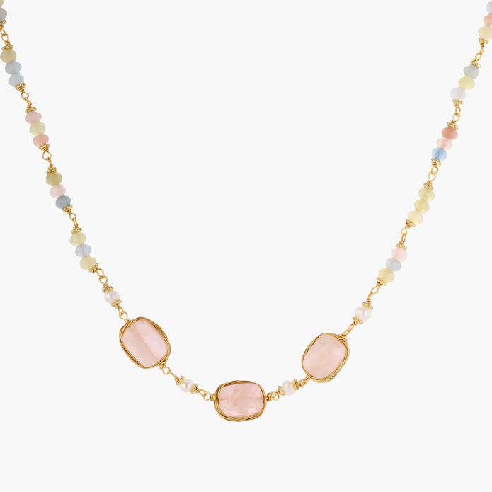 Gold necklace with three rose quartz stones, multicolor pastel beads, and pearl accents on white background.