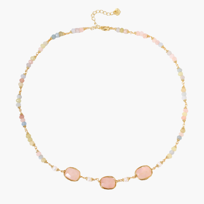 Gold necklace with three rose quartz stones, multicolor pastel beads, and pearl accents on white background.