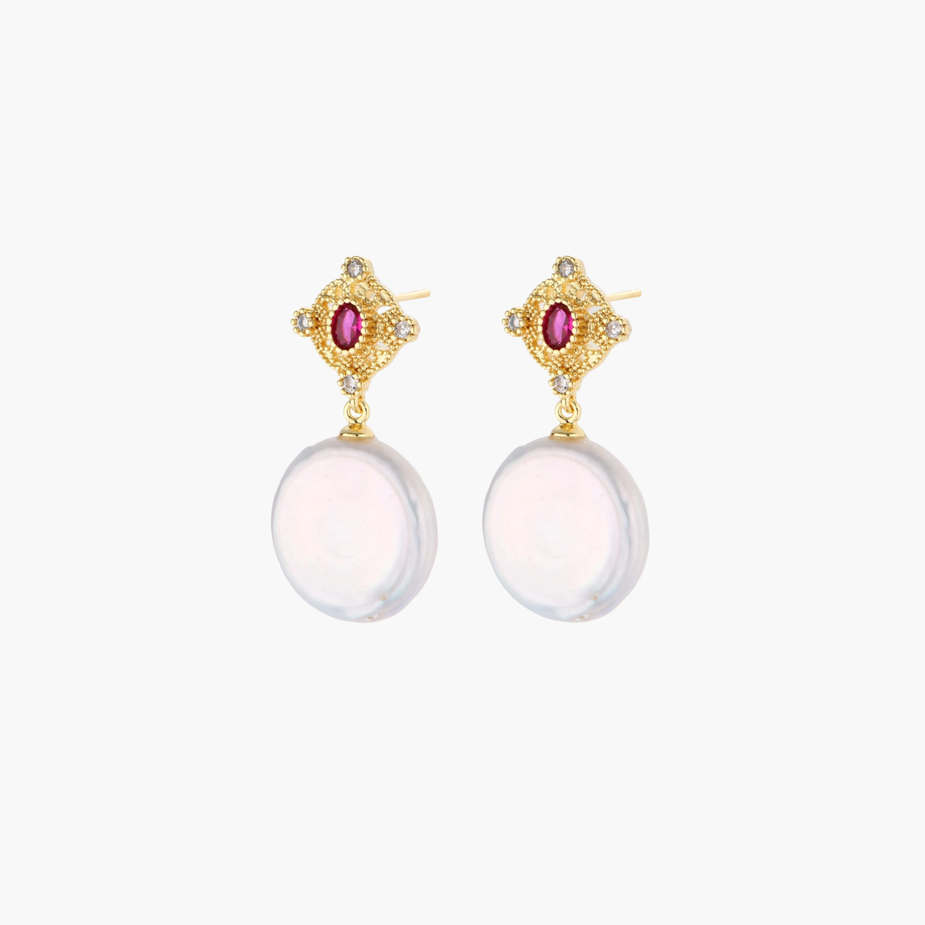 Gold baroque pearl earrings with pink gemstone studs and ornate detailing on cream background.