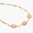 Gold necklace with three rose quartz stones, multicolor pastel beads, and pearl accents on white background.