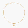 Delicate gold-plated necklace with three interlocking circle rings forming a minimalist knot pendant on cream background