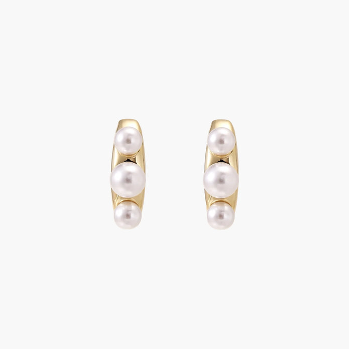 14K gold-plated curved stud earrings with three white freshwater pearls aligned vertically on cream background