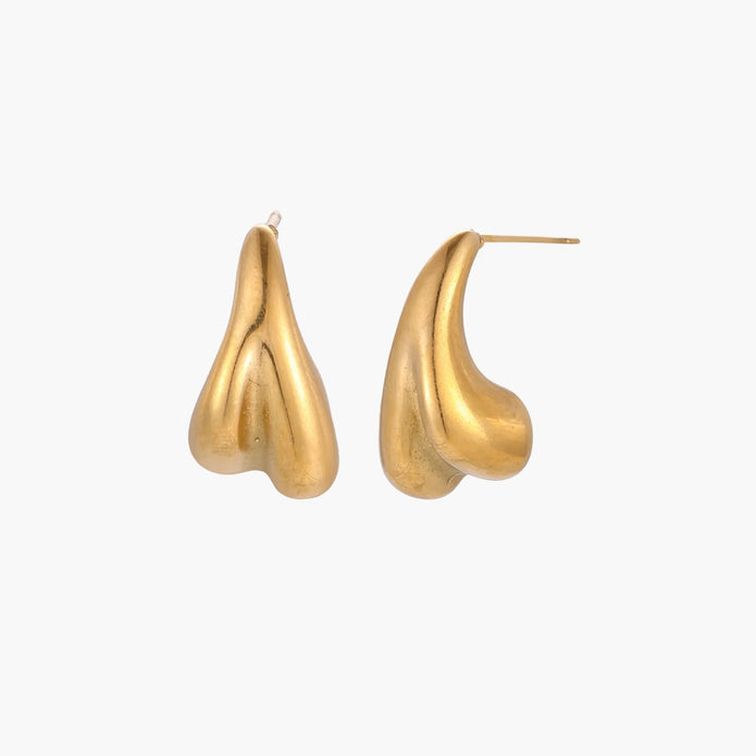 Pair of sculptural gold stud earrings with twisted organic forms on cream background