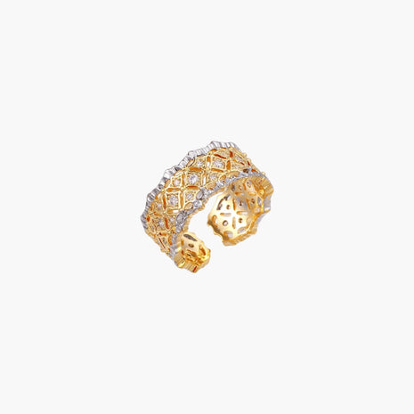 Two-tone ring with geometric lattice pattern in gold and silver finish with crystal accents on beige background