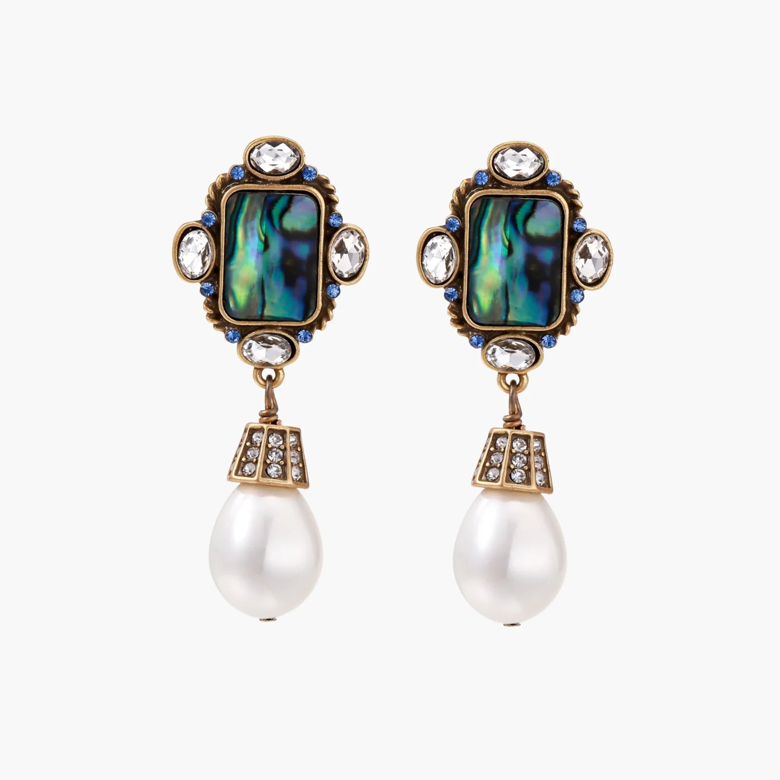 Ornate gold-plated earrings with iridescent abalone shell, crystals, blue stones, and white pearl drops on cream background.