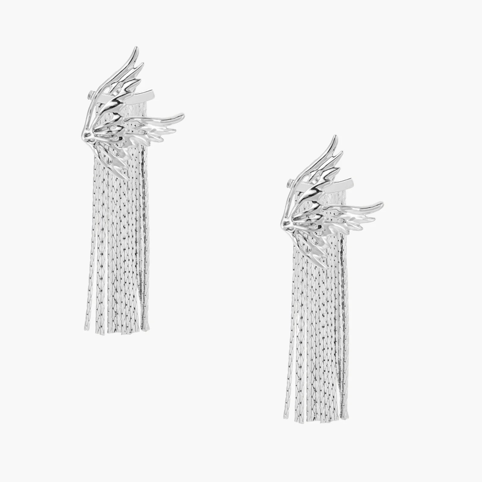 Sculptural white gold plated wing earrings with long chain tassel fringe on cream background
