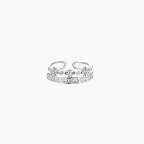Silver-toned adjustable crown ring with channel-set square zirconia stones and delicate floral details on white background