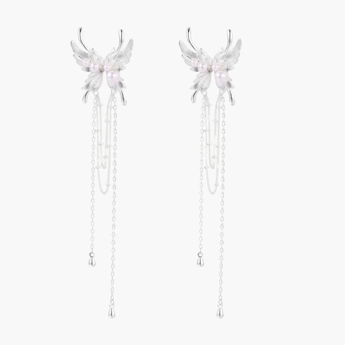 Elegant chandelier earrings with phoenix wing design, white pearls, and cascading silver chains on cream background