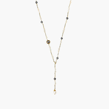 Y-shaped gold-plated necklace with white and gray freshwater pearls on cream background, showing adjustable drop design.