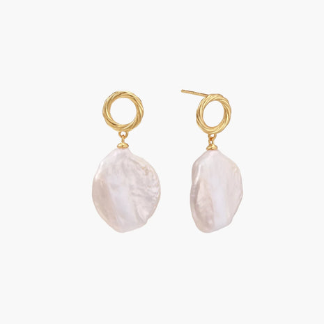 18K gold vermeil twisted circle studs with organic white baroque pearl drops on cream background