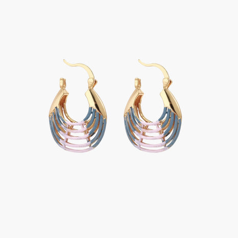 Gold hoop earrings with gradient blue-to-pink enamel in ribbed fan design on beige background