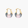 Gold hoop earrings with gradient blue-to-pink enamel in ribbed fan design on beige background