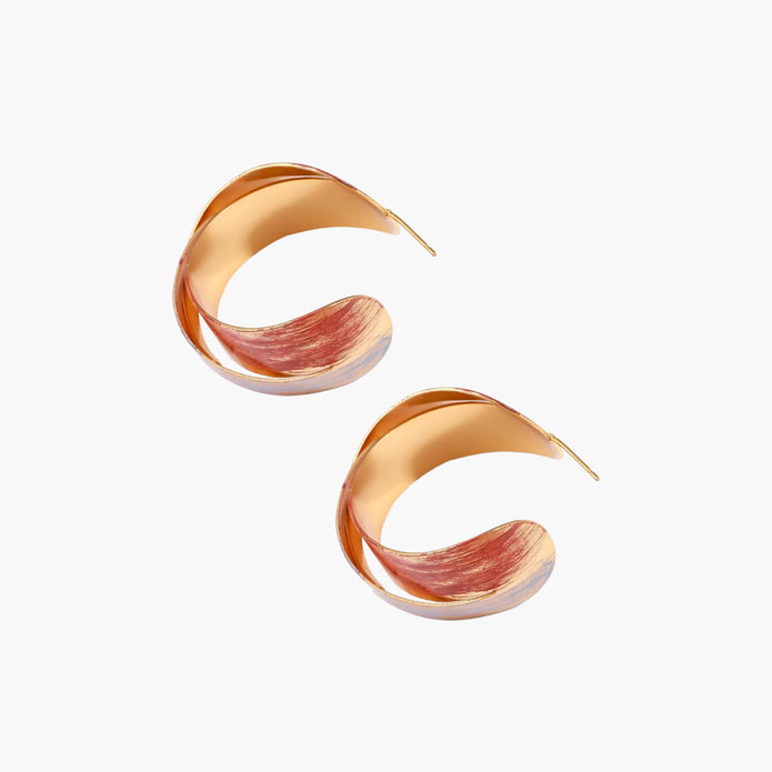 Sculptural gold-plated hoop earrings with diagonal purple and coral enamel stripes in twisted ribbon design