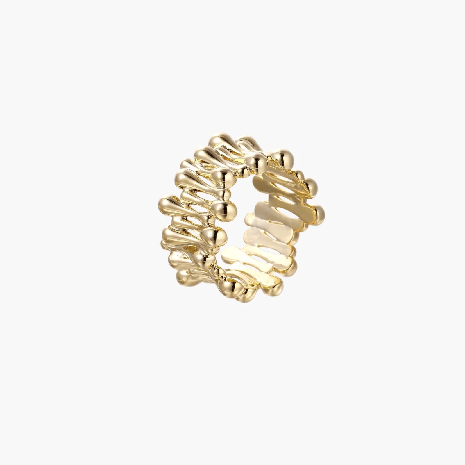 Gold-plated brass ring with sculptural petal-like elements in a wide band design on beige background