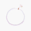Double-wrap lavender beaded bracelet with rose quartz, pearls, gold vermeil charm and pink tassel on white background.