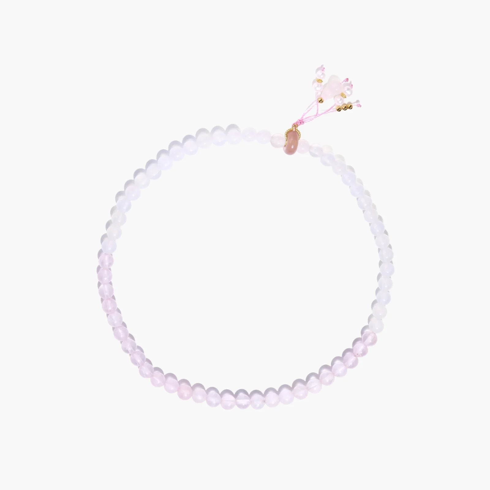 Double-wrap lavender beaded bracelet with rose quartz, pearls, gold vermeil charm and pink tassel on white background.