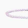 Double-wrap lavender beaded bracelet with rose quartz, pearls, gold vermeil charm and pink tassel on white background.