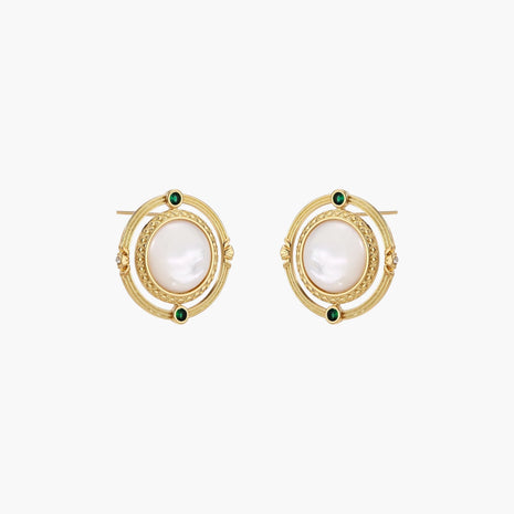 Circular gold stud earrings with iridescent mother-of-pearl center and green zirconia accents on cream background.