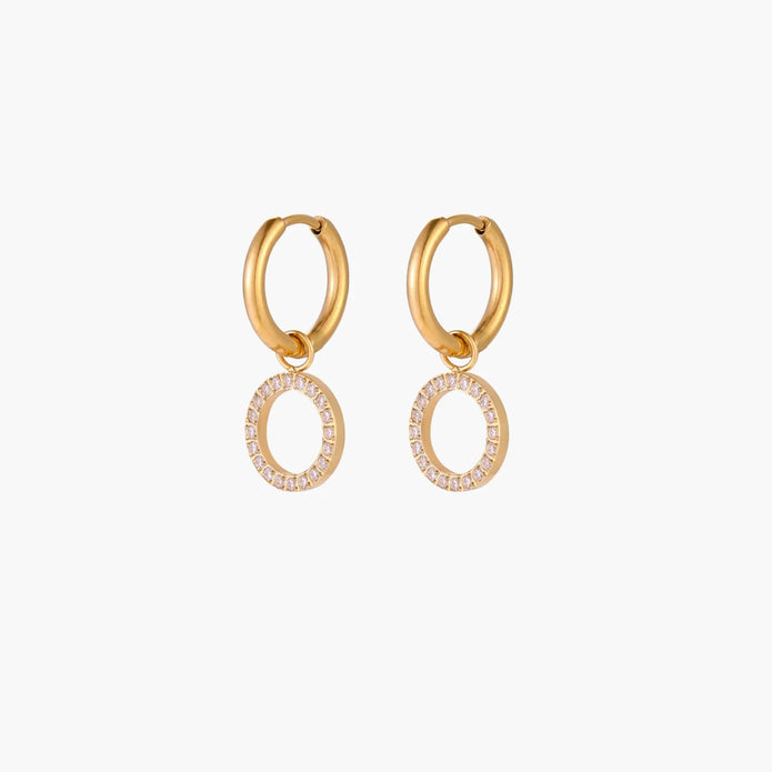 Gold-plated huggie hoop earrings with CZ-studded open circle charms on beige background