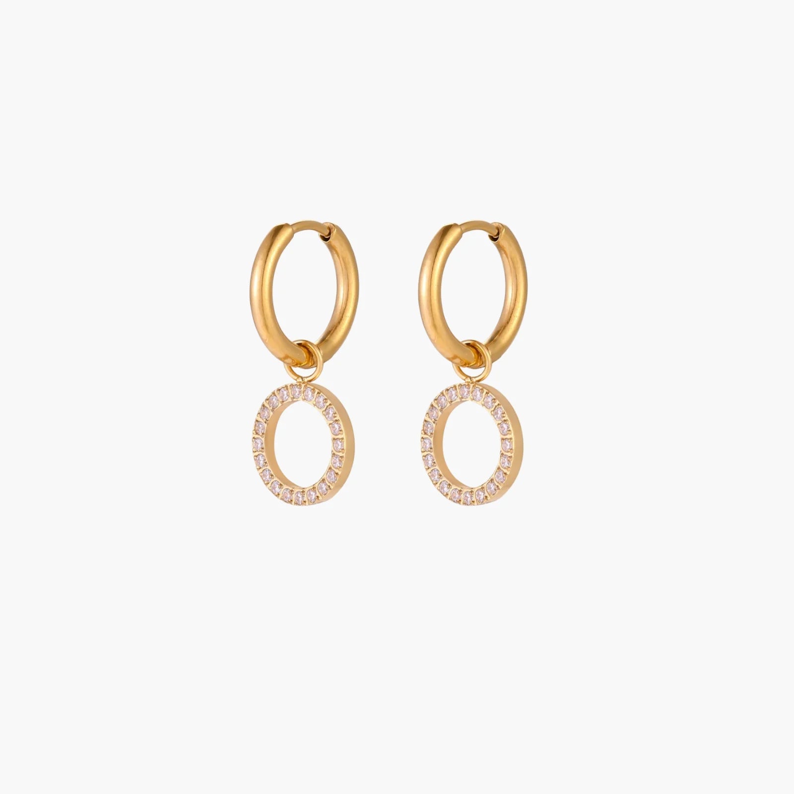 Gold-plated huggie hoop earrings with CZ-studded open circle charms on beige background