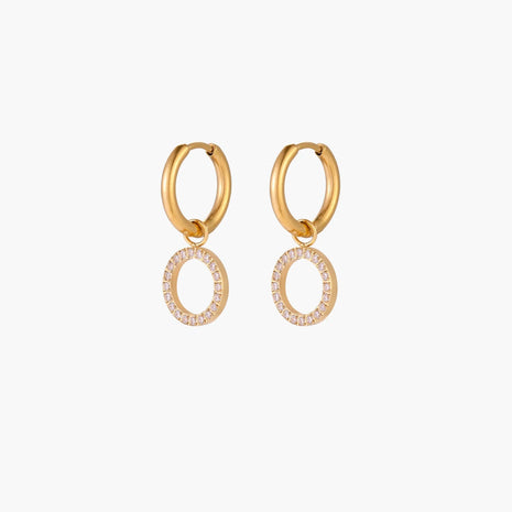 Gold-plated huggie hoop earrings with CZ-studded open circle charms on beige background