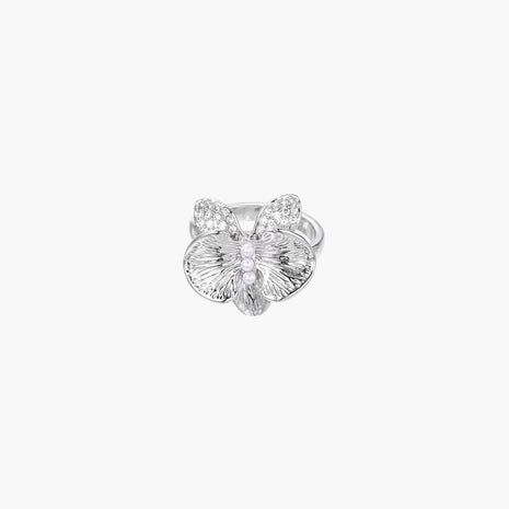 Silver-toned orchid ring with textured petals, pearl center accents, and sparkling zirconia stones on white background.