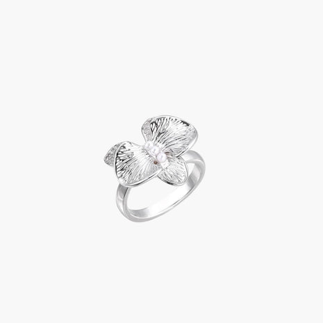 Silver-toned orchid ring with textured petals, pearl center accents, and sparkling zirconia stones on white background.