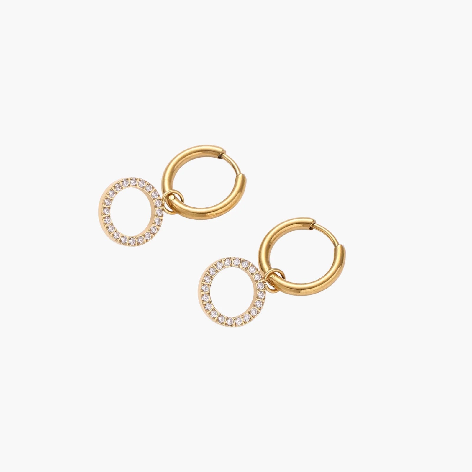 Gold-plated huggie hoop earrings with CZ-studded open circle charms on beige background
