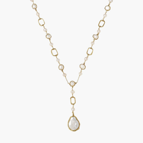 Y-shaped gold necklace with alternating geometric links, freshwater pearls, and baroque pearl pendant on cream background