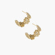 Gold hoop earrings with intricate three-dimensional floral filigree pattern in 14K gold plated brass on cream background