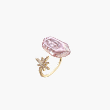 Adjustable gold ring with pink baroque freshwater pearl and crystal-studded star charm on white background