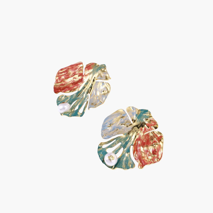 Artistic monstera-shaped earrings with teal, coral, and cream enamel brushstrokes, gold trim, and white pearl accent