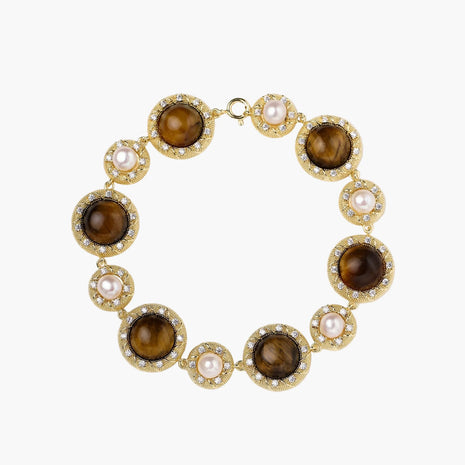 Gold-plated link bracelet with alternating brown tiger's eye stones and white freshwater pearls in ornate bezels.