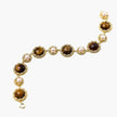 Gold-plated link bracelet with alternating brown tiger's eye stones and white freshwater pearls in ornate bezels.