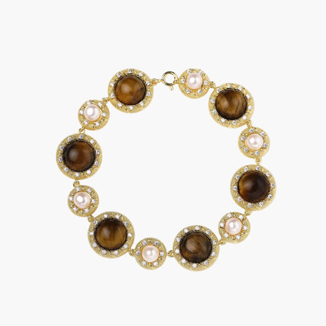 Gold-plated link bracelet with alternating brown tiger's eye stones and white freshwater pearls in ornate bezels.