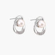 White gold-plated brass earrings with circular design, freshwater pearl center, and diamond accents