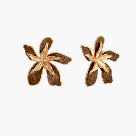 Gold-plated brass flower earrings with brown tortoiseshell enamel petals on cream background