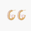 Gold pavé hoop earrings with two freshwater pearls nestled inside the curved design, featuring crystal-studded outer edge.