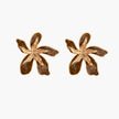 Gold-plated brass flower earrings with brown tortoiseshell enamel petals on cream background